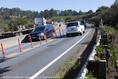 State Route 92 near Half Moon Bay in San Mateo County. Photograph shows one lane of traffic traveling in each direction while Caltrans works on the other side of a barrier alongside the roadway.