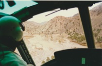 A helicopter pilot surveys the damage to U.S. 395 in Walker Canyon on January 3, 1997, following historic flooding.