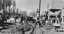 A black and white picture of Main Street in Bishop in 1934. Tracks are being installed.