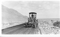 A black and white picture of an old vehicle the Division of Highways used to build highways in 1934.