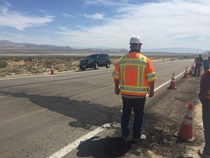 A Caltrans employee observes the repair process to State Route 178 following the Ridgecrest earthquake in July, 2019.