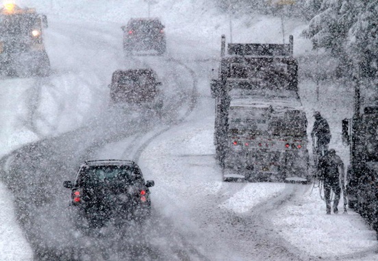 A series of cars drive through heavy snow on State Route 203 in May, 2017.