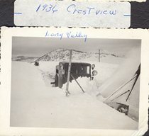 A black and white image of a snowblower removing snow from the road. Writing on the image reads "1936 Crestview. Long Valley." Previous ImageNext Image Close