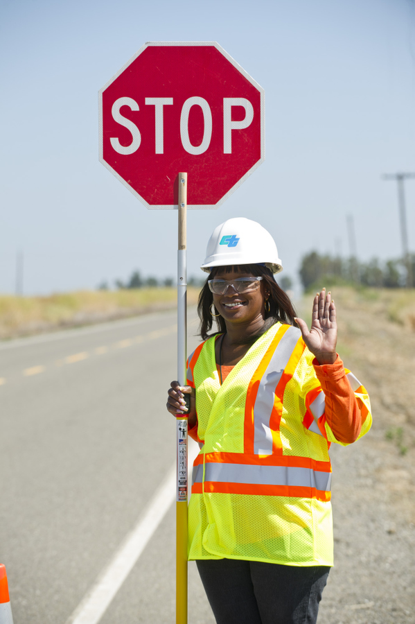 Flagging operator demonstrating the position to stop traffic